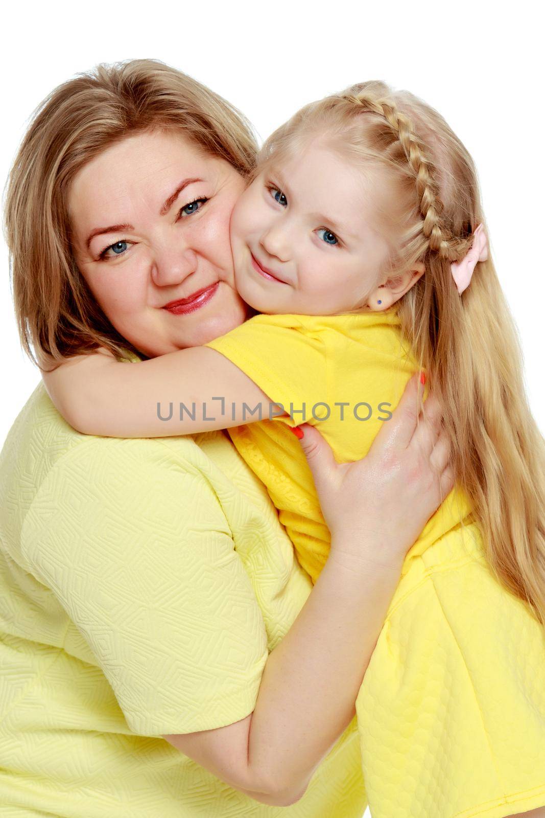 A happy mother hugs her beloved daughter. by kolesnikov_studio