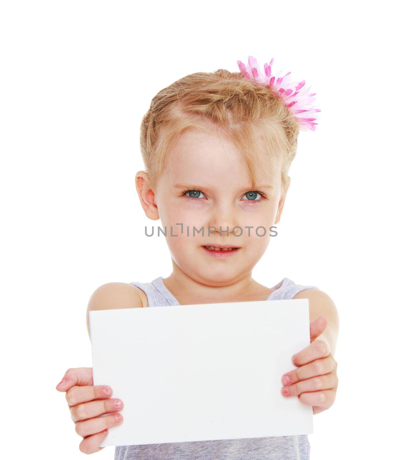 Little girl holding a sheet of paper in front of him. Isolated on white background .