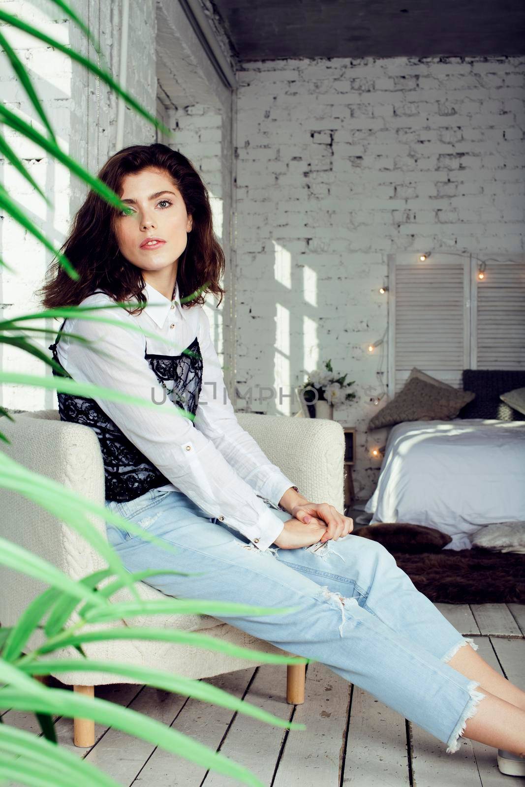 young pretty woman in her bedroom sitting in chair, lifestyle people concept close up