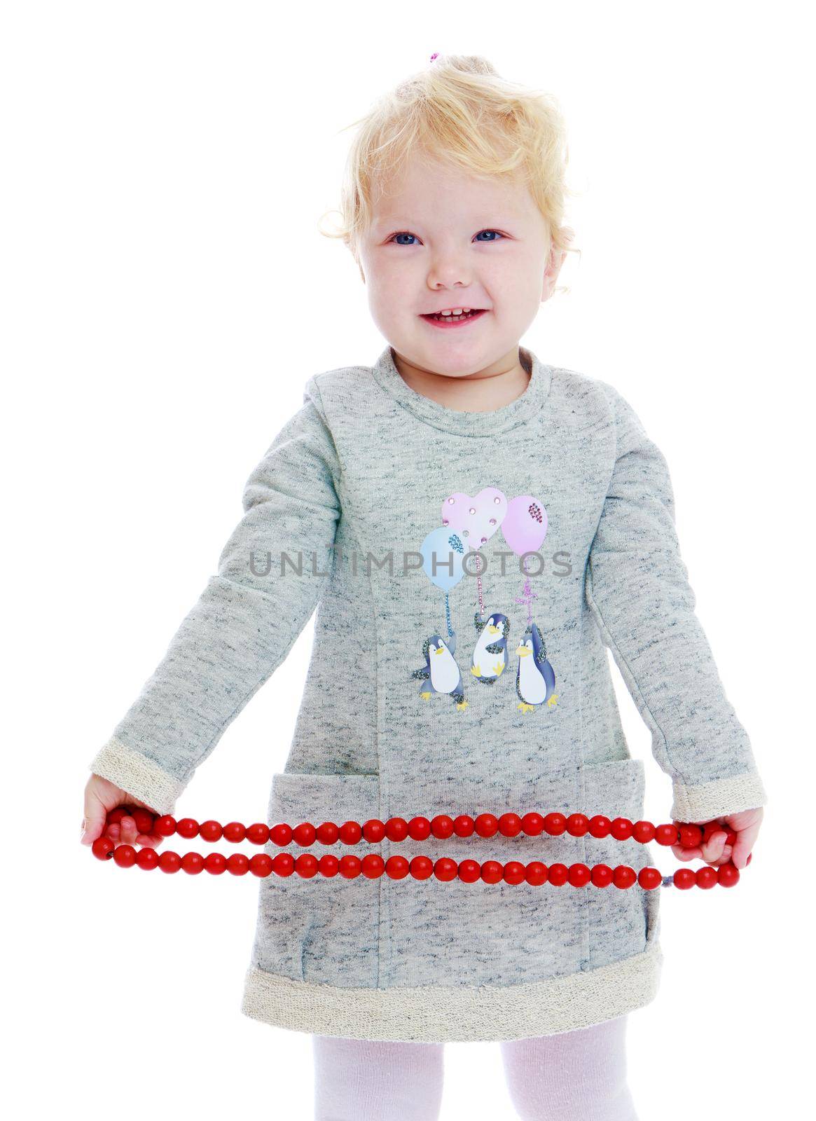 little girl.Charming girl with red beads in his hands