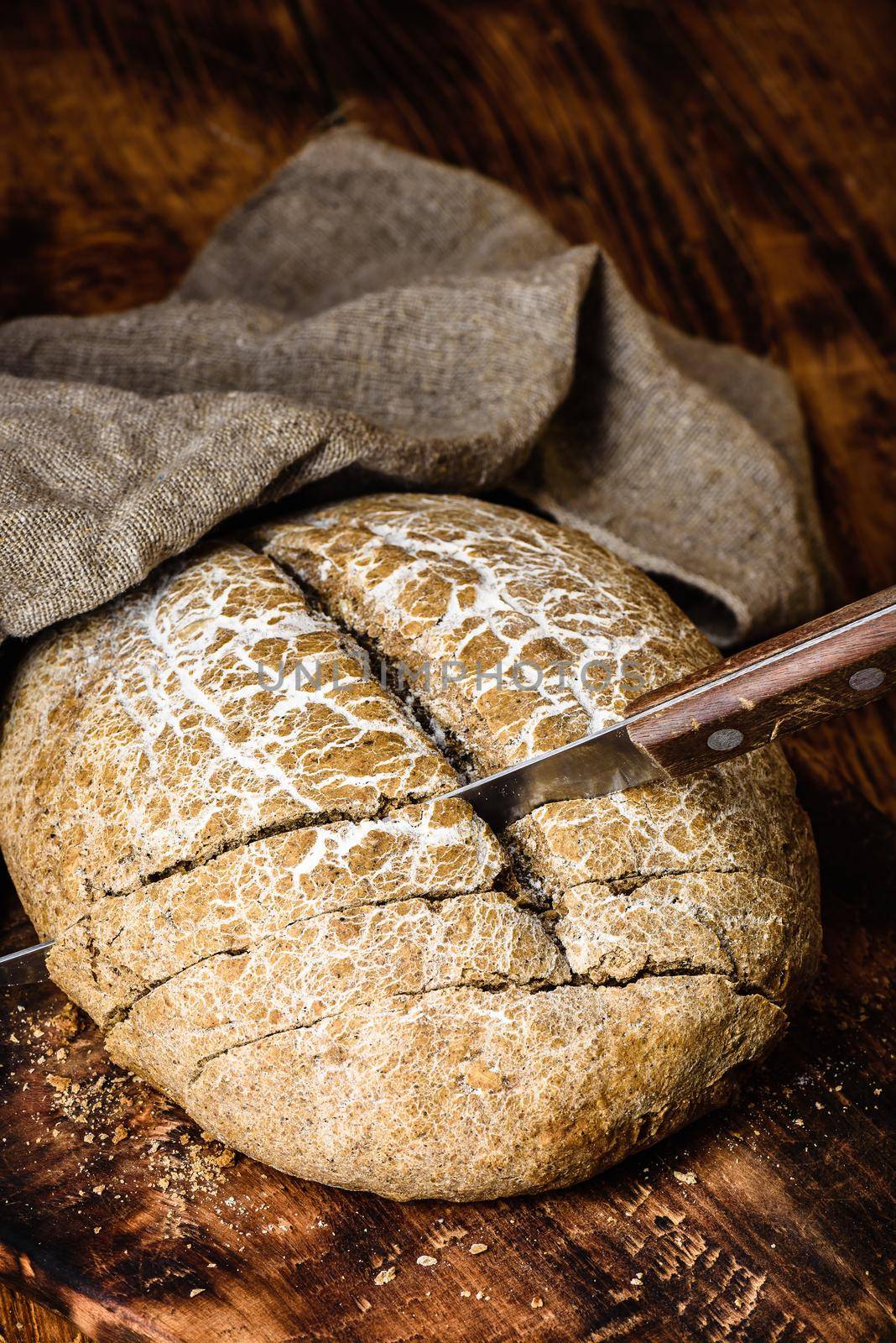 Slices of home baked rye bread on cutting board with knife