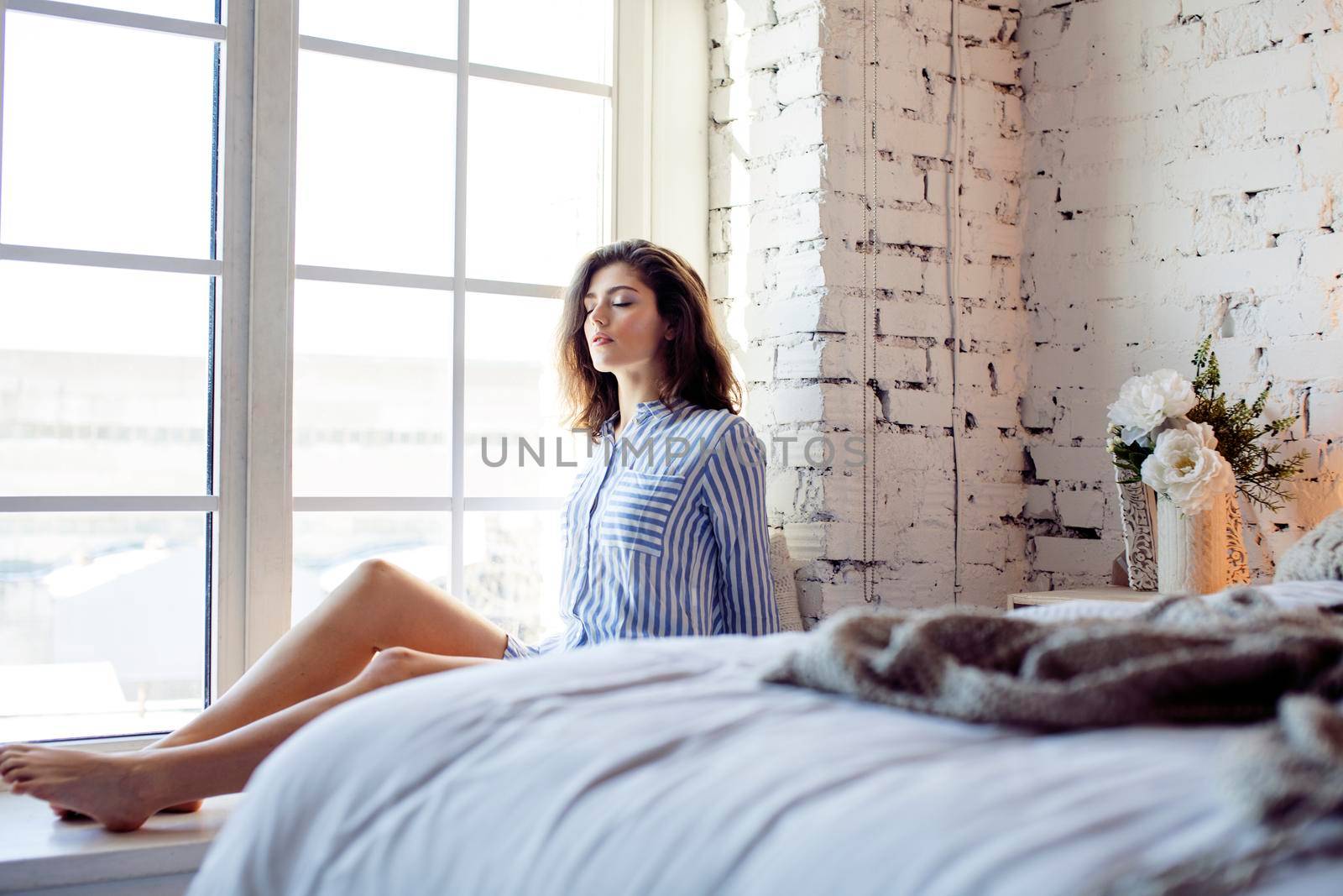 young pretty brunette woman in her bedroom sitting at window, happy smiling lifestyle people concept by JordanJ