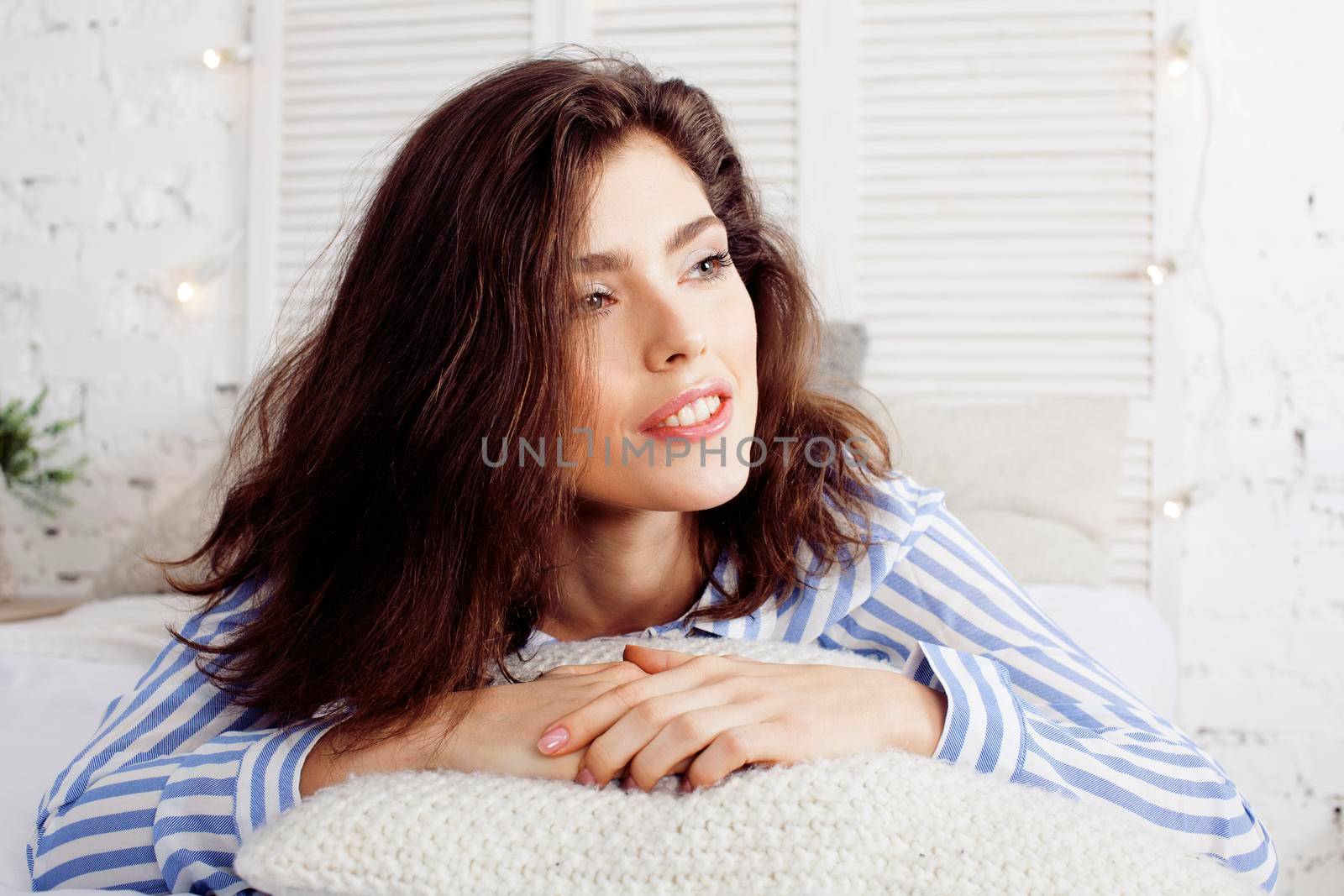 young pretty brunette woman in her bedroom sitting at window, happy smiling lifestyle people concept close up