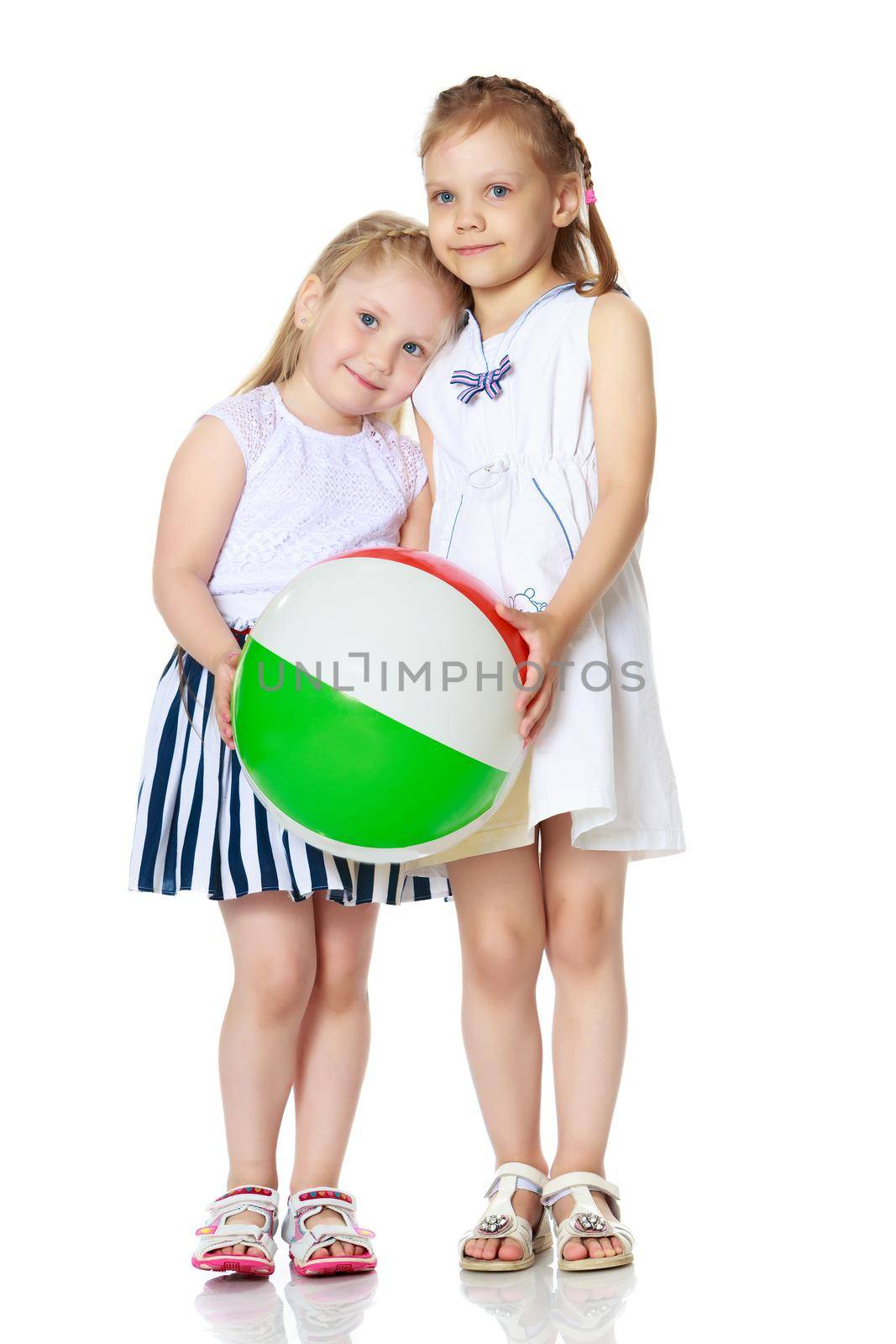 Two little girls are playing with a ball. Game concept, rest on the sea.Isolated on white background.