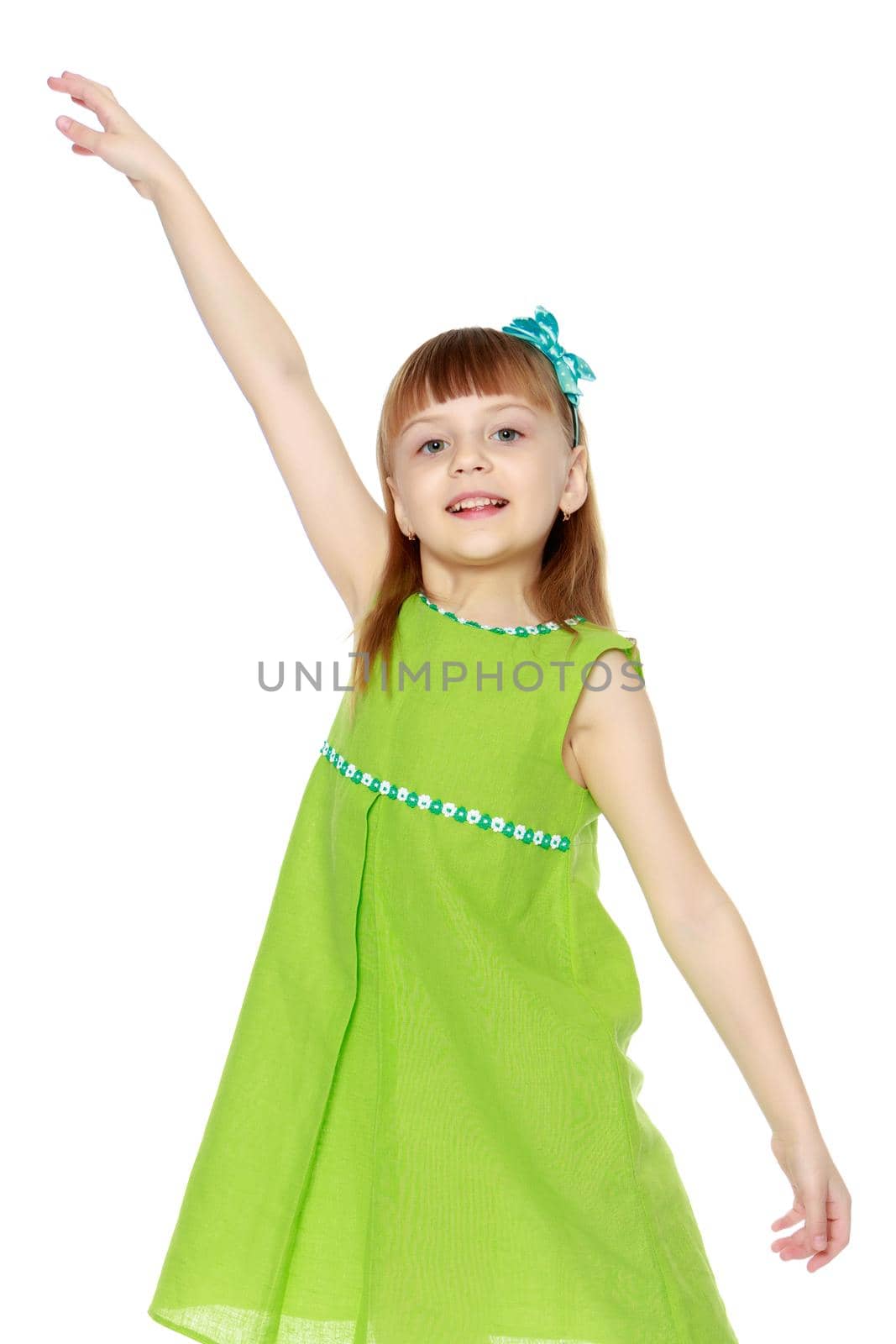 A little girl with long blond hair and a short bangs, in a short summer dress.The girl raised her hand up.