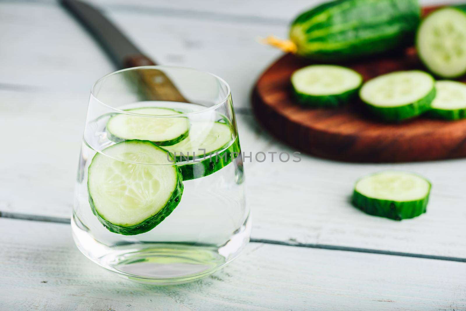 Infused water with sliced cucumber in a drinking glass