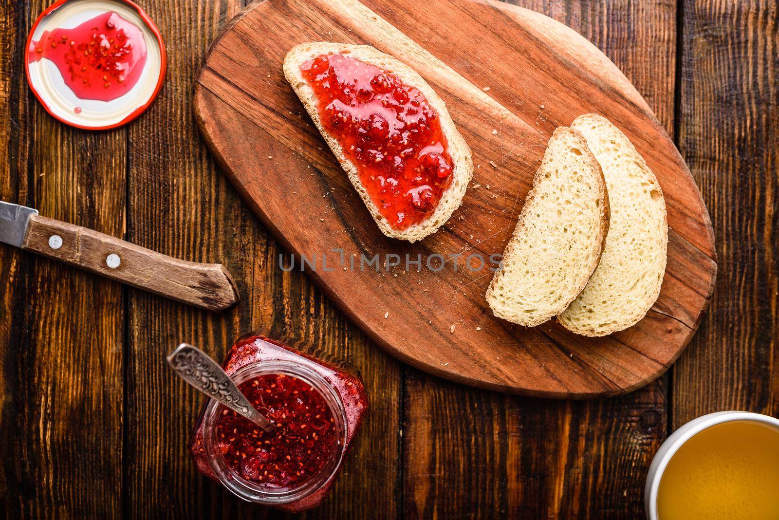 Toast with homemade raspberry jam with cup of green tea
