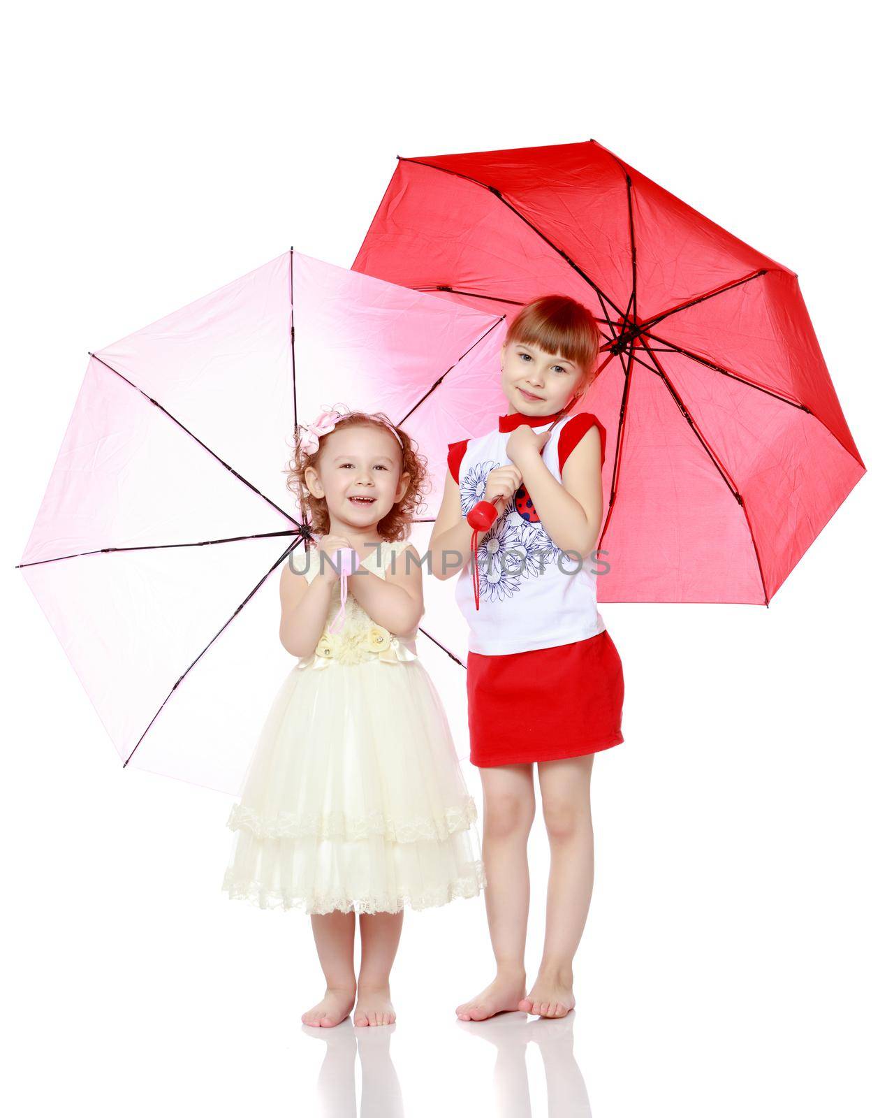 Two charming little girls, little sister and the eldest, sheltered from rain or sun under umbrellas.