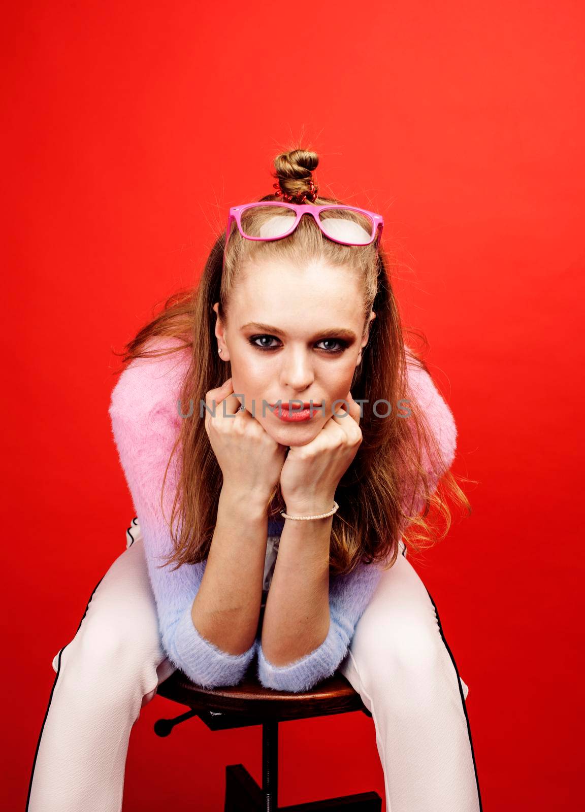 young pretty emitonal posing teenage girl on bright red background, happy smiling lifestyle people concept by JordanJ