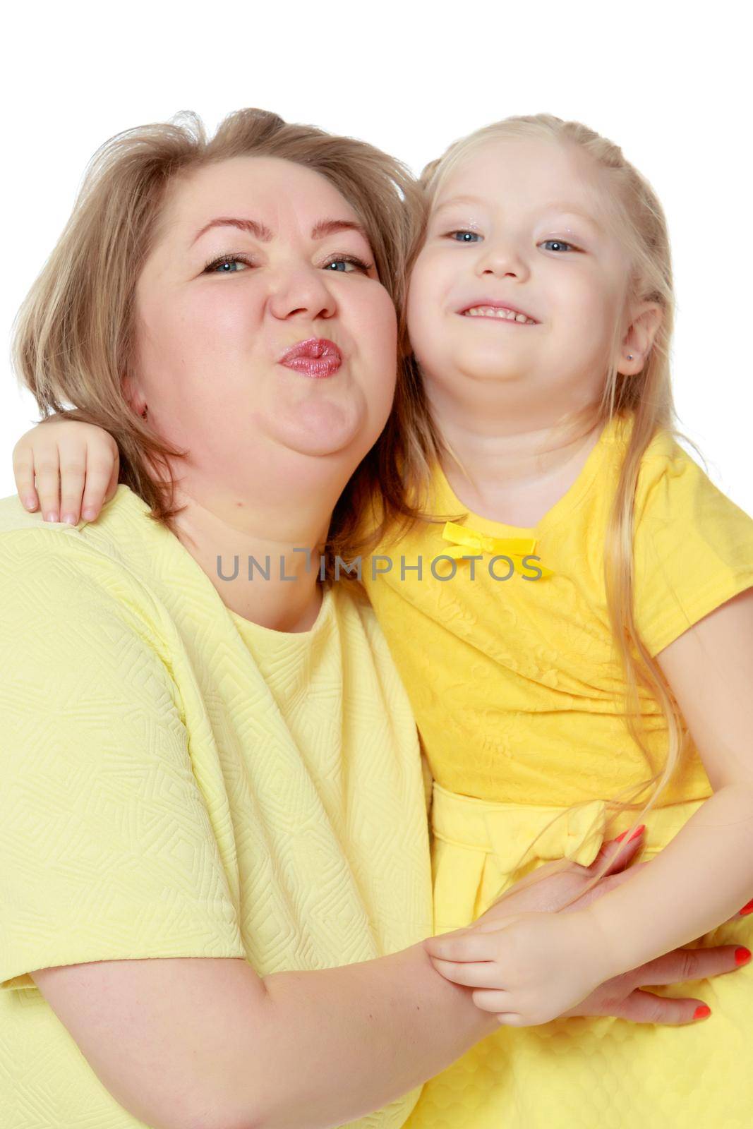 Mom and little daughter plus the size of the model, gently embrace. A woman and her daughter are smiling in a happy manner. Good for the concept of health, happiness, diet, obesity, weight loss.