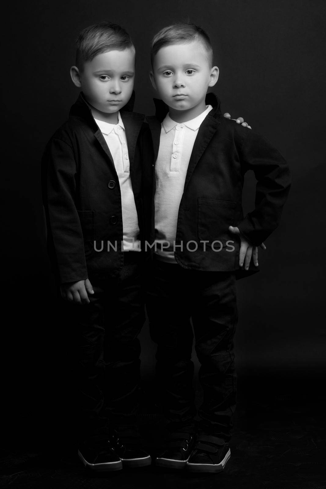 two little boys dressed in tuxedo. Isolated on white background