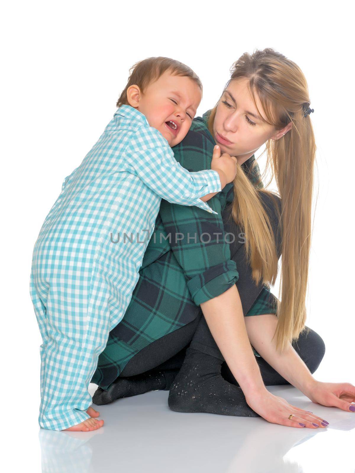 Mom holds on the shoulders of the baby. The concept of happy motherhood, family happiness, child development. Isolated on white background.