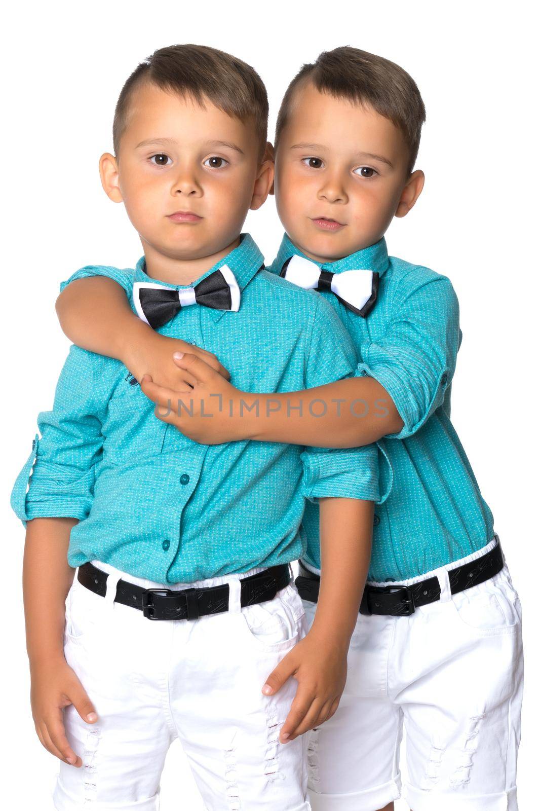 Two little brothers of Gemini together are sad. Isolated on white background