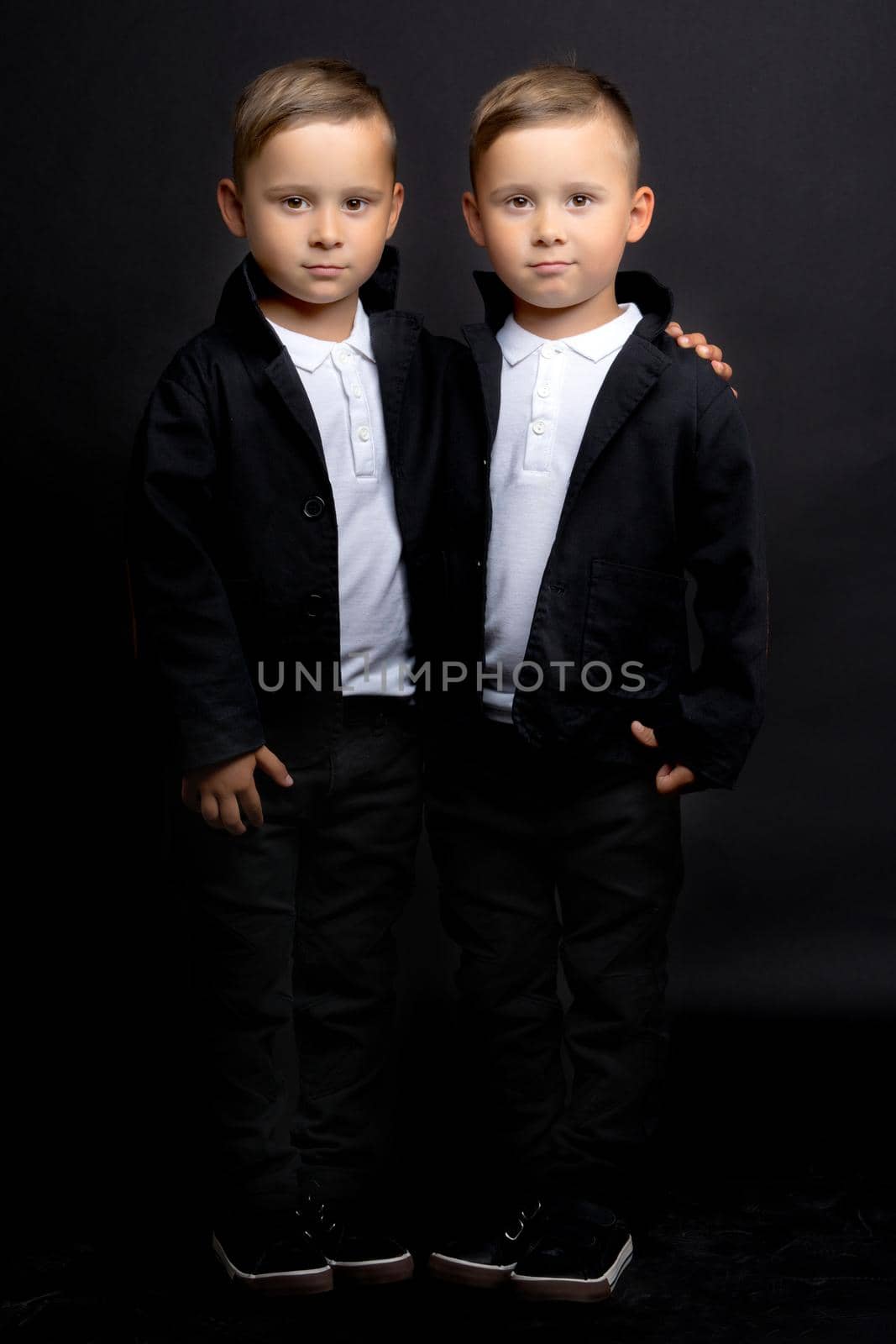 two little boys dressed in tuxedo. Isolated on white background