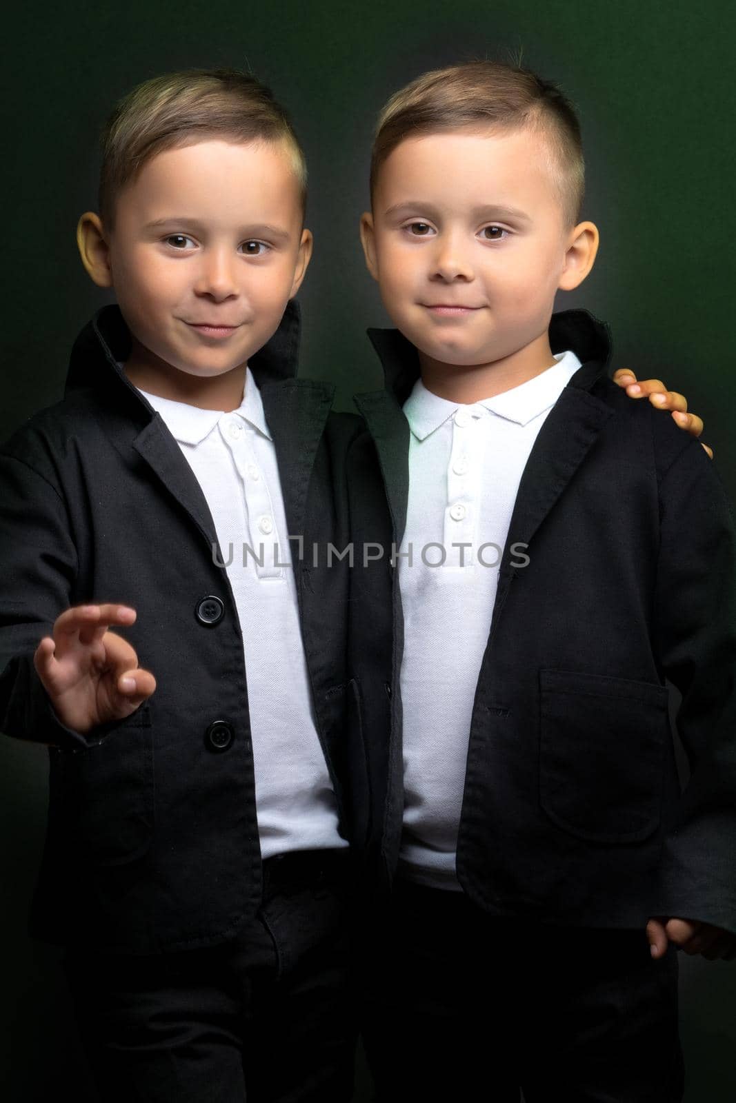 Two beautiful boys in black suits by kolesnikov_studio