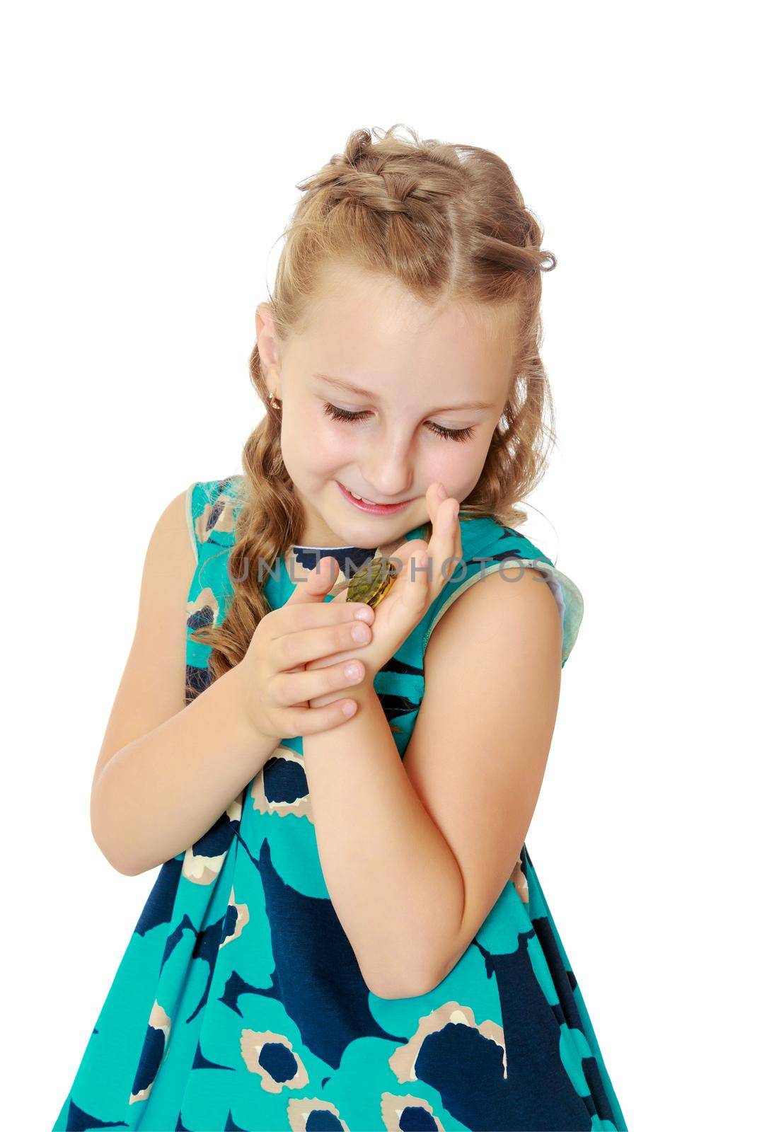 Charming little girl holding in hands a small turtle. Close-up.Isolated on white background.