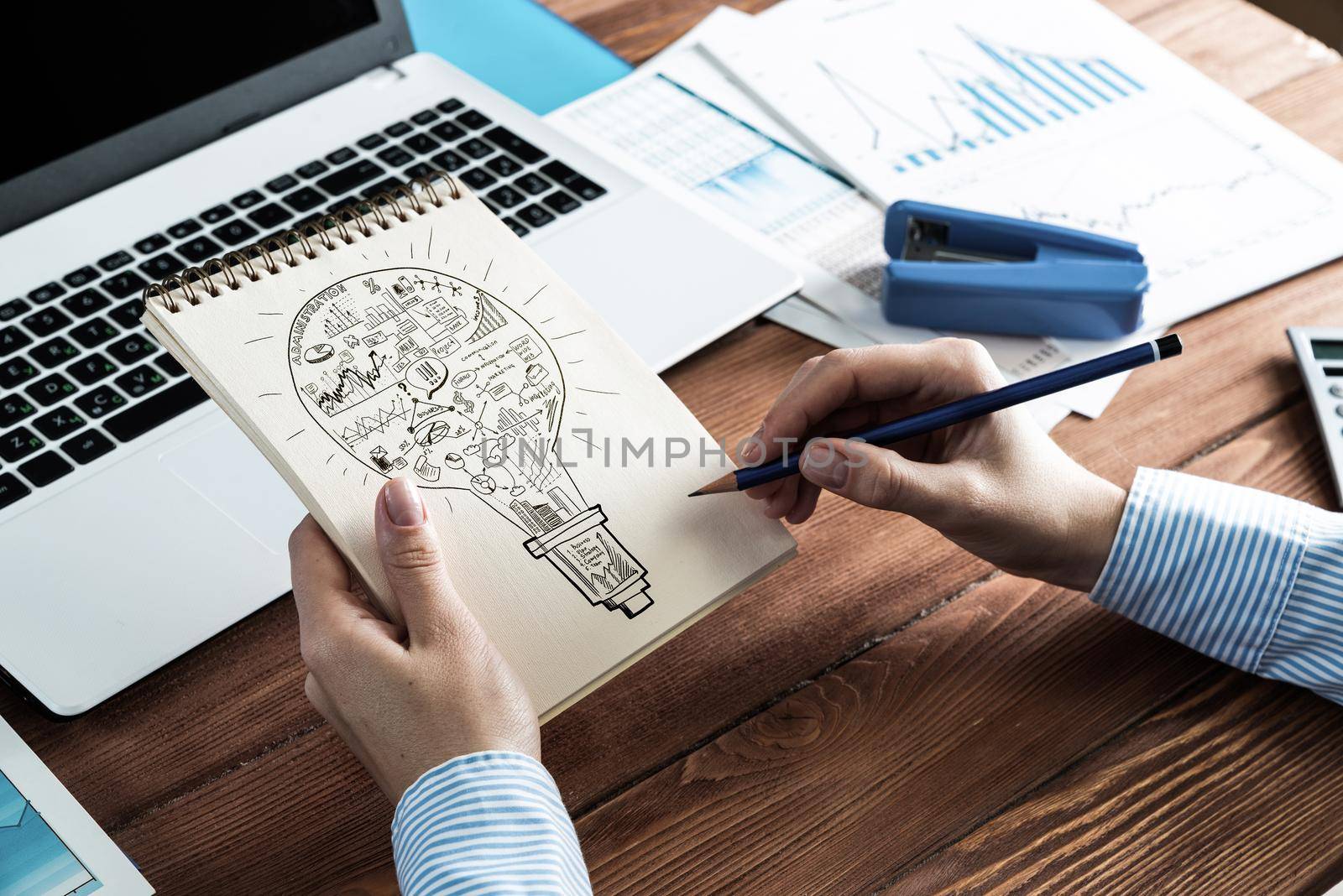 close-up, woman draws business notes in her notebook. Business Innovation Concept