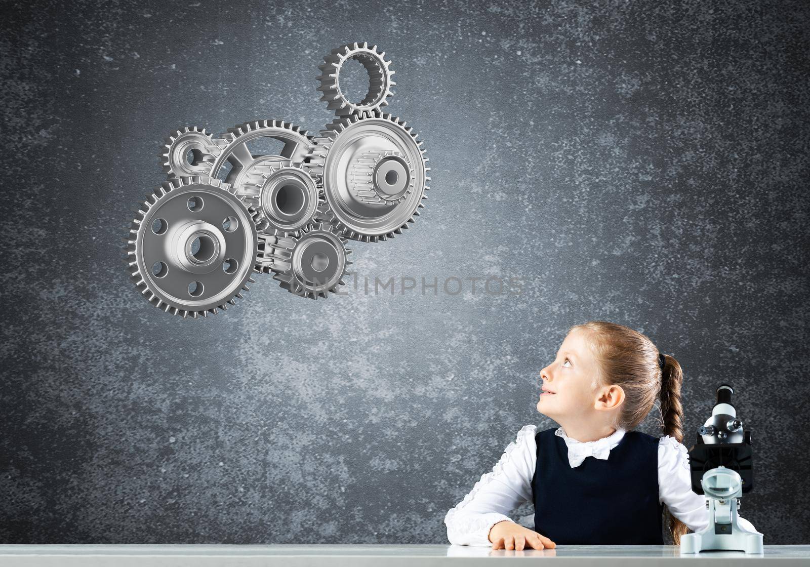 Little girl scientist with microscope on chalkboard background with gears mechanism. Research and discovery concept. Elementary science class in modern school. Schoolgirl in schoolwear sitting at desk