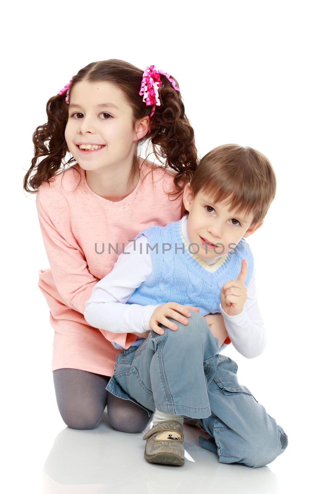 Brother and sister hugging each other. Boy and girl very happy.Isolated on white background.