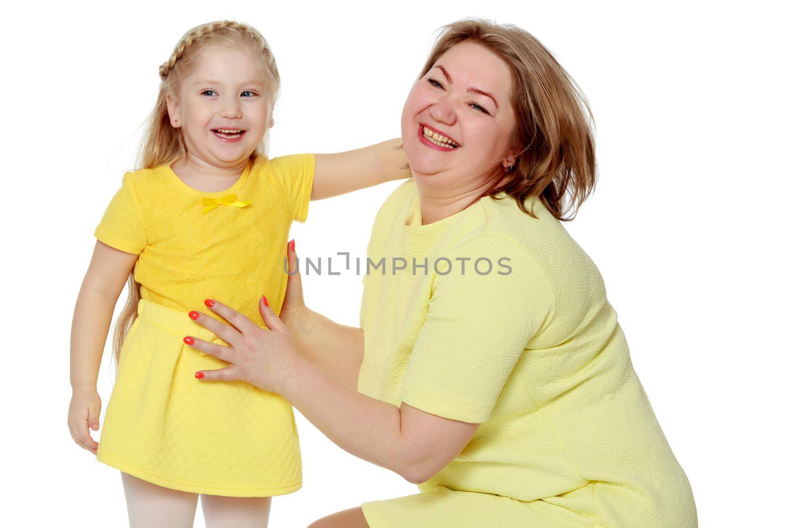 Mom and little daughter plus the size of the model, gently embrace. A woman and her daughter are smiling in a happy manner. Good for the concept of health, happiness, diet, obesity, weight loss.
