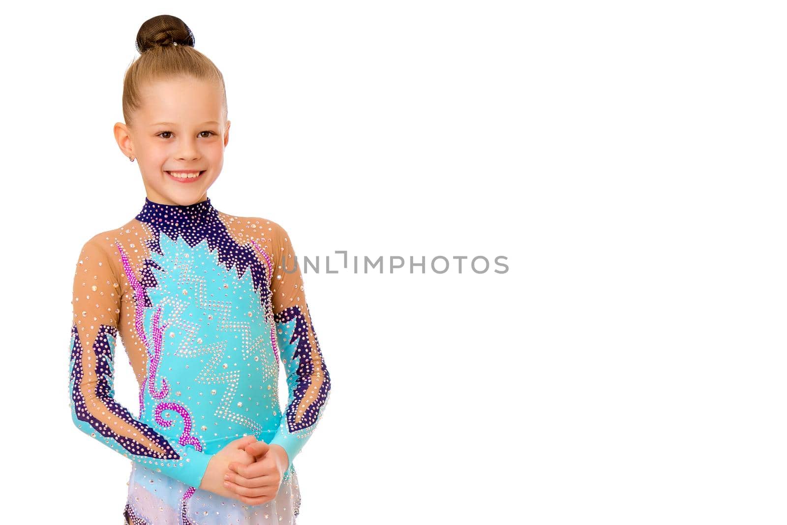 Little girl gymnast in a beautiful sports swimsuit for competitions, close-up. The concept of sport and fitness, a happy childhood. Isolated on white background.