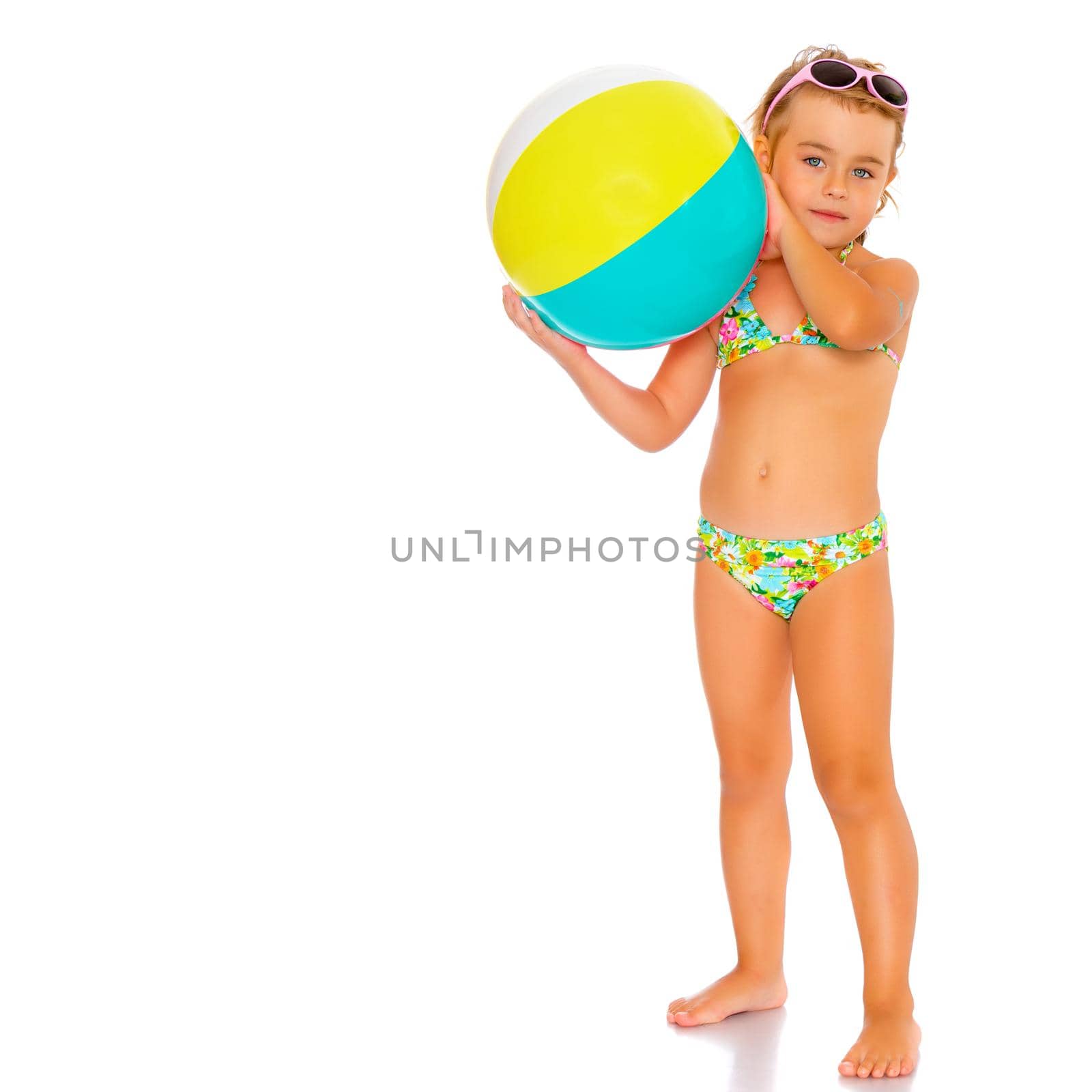 Little girl in a swimsuit with a ball by kolesnikov_studio