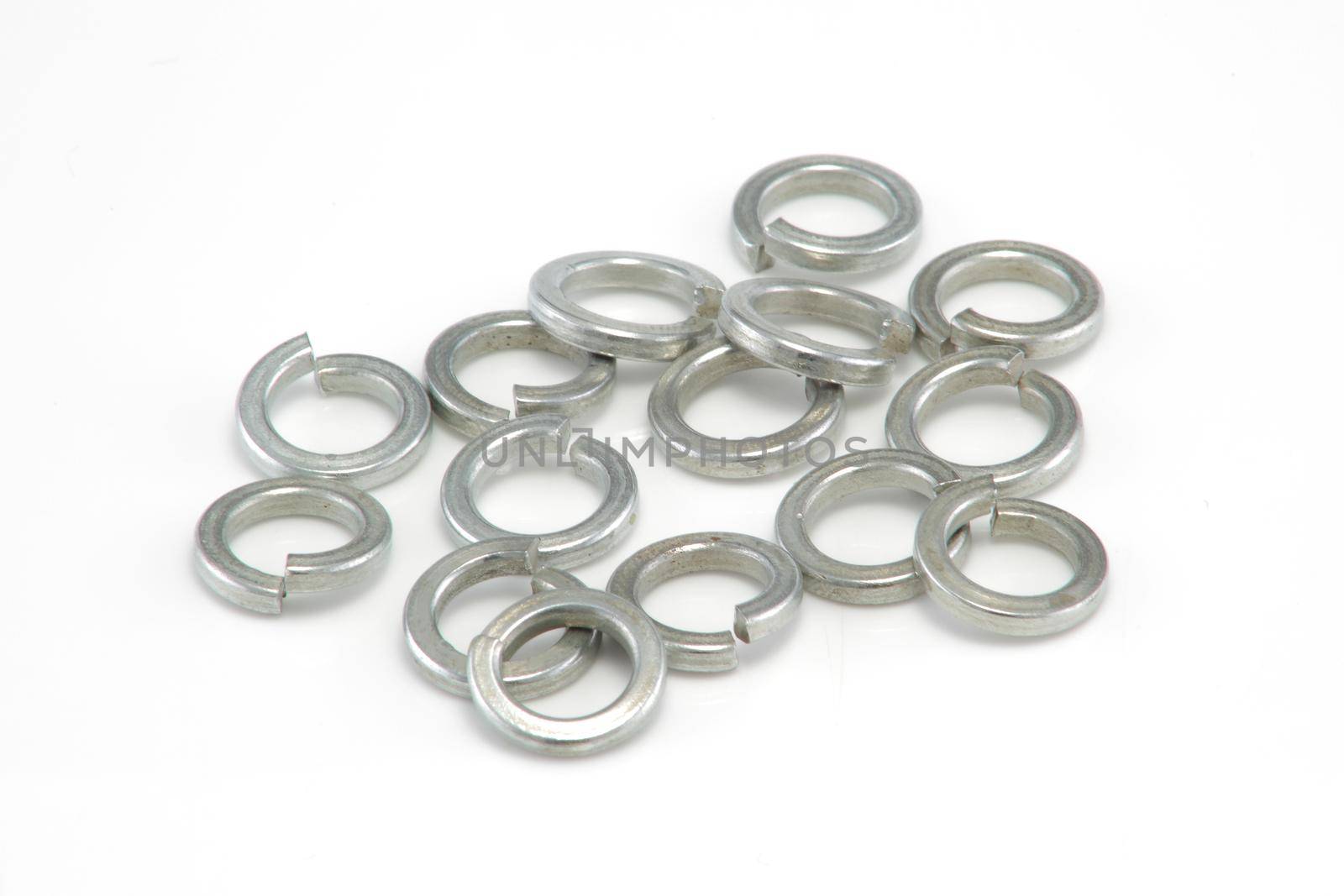 A heap of 8mm split spring washers on white background