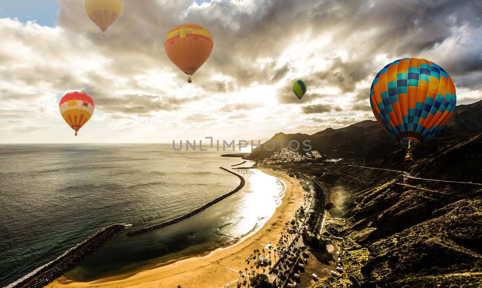 Hot air balloon over the sea at Sunset with dramatic sky background.