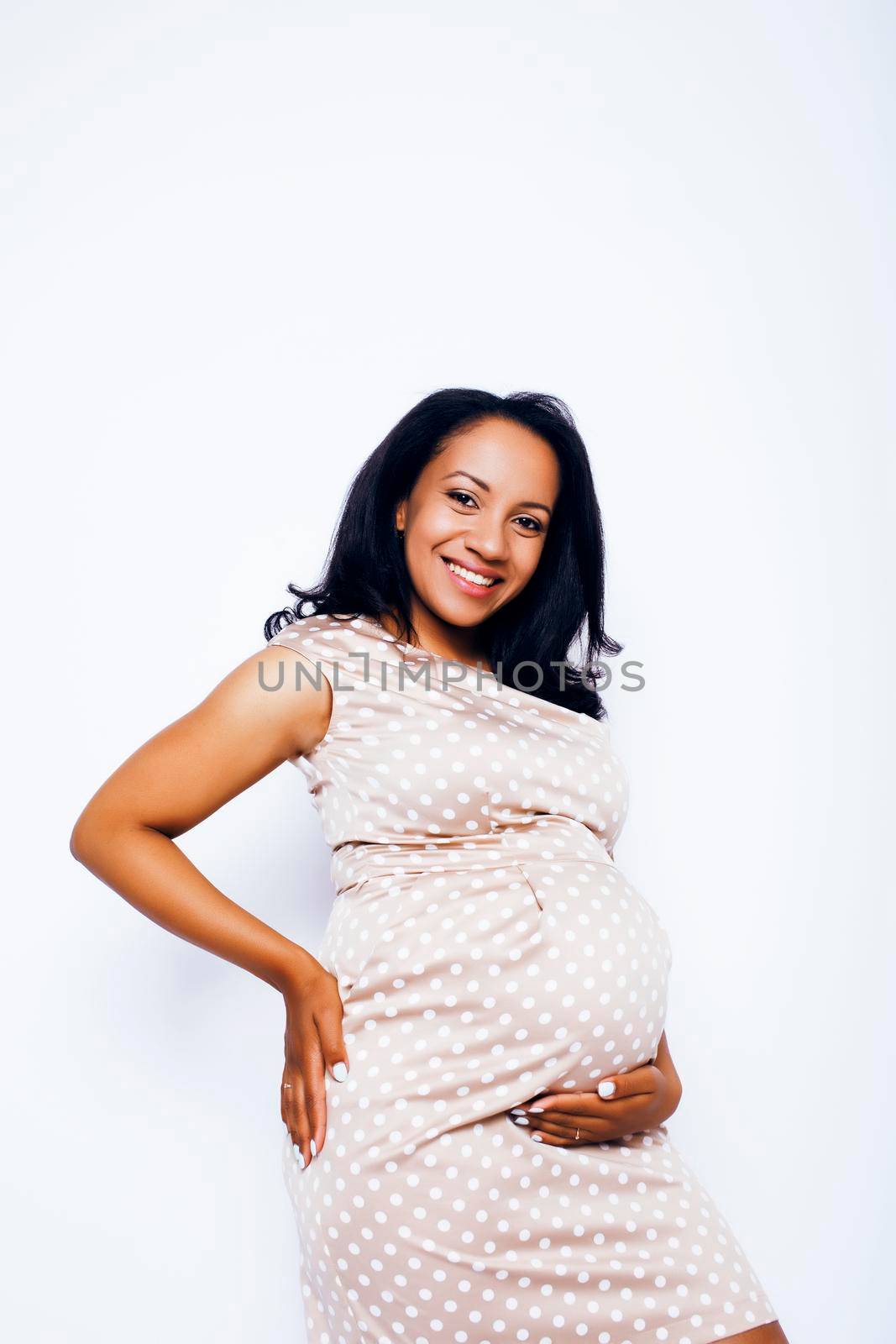young pretty african american woman pregnant happy smiling, posing on white background isolated , lifestyle people concept by JordanJ