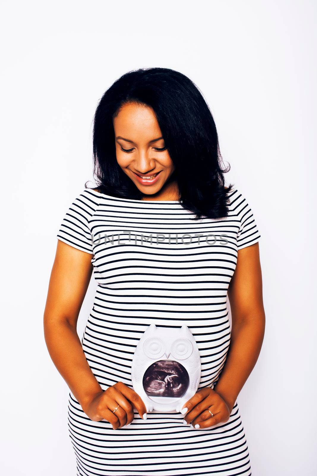 young pretty african american woman pregnant happy smiling, posing on white background isolated , lifestyle people concept copyspace close up