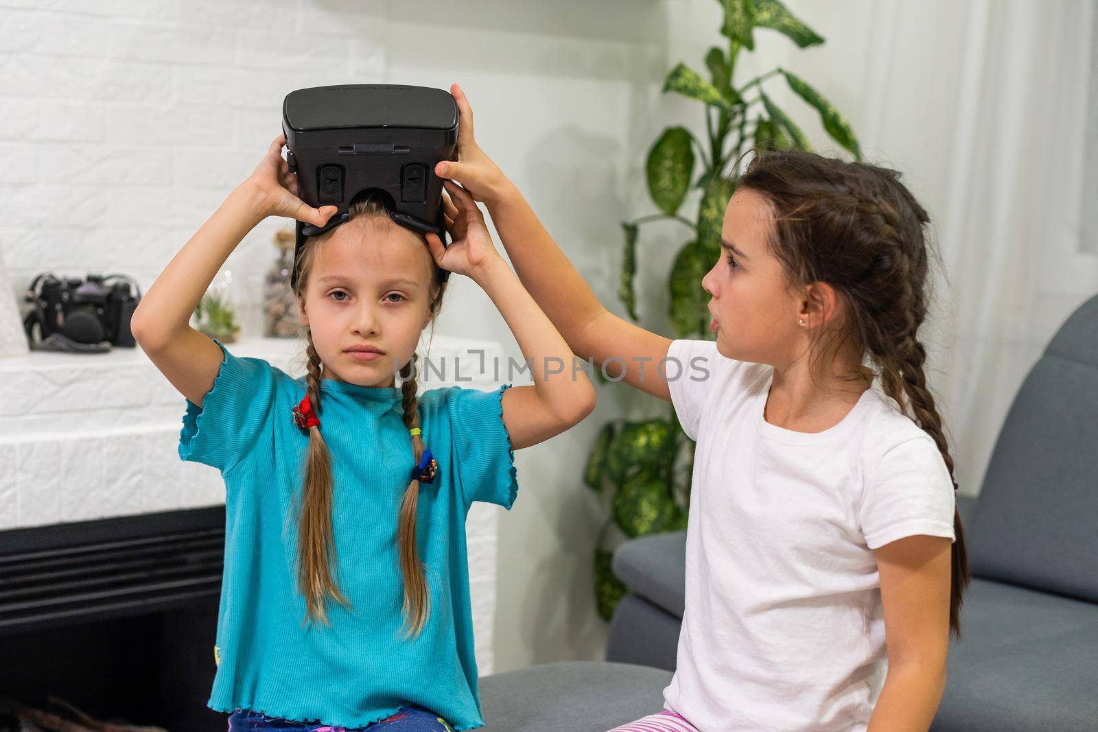 two little girls using glasses of virtual reality headset. concept of modern technologies