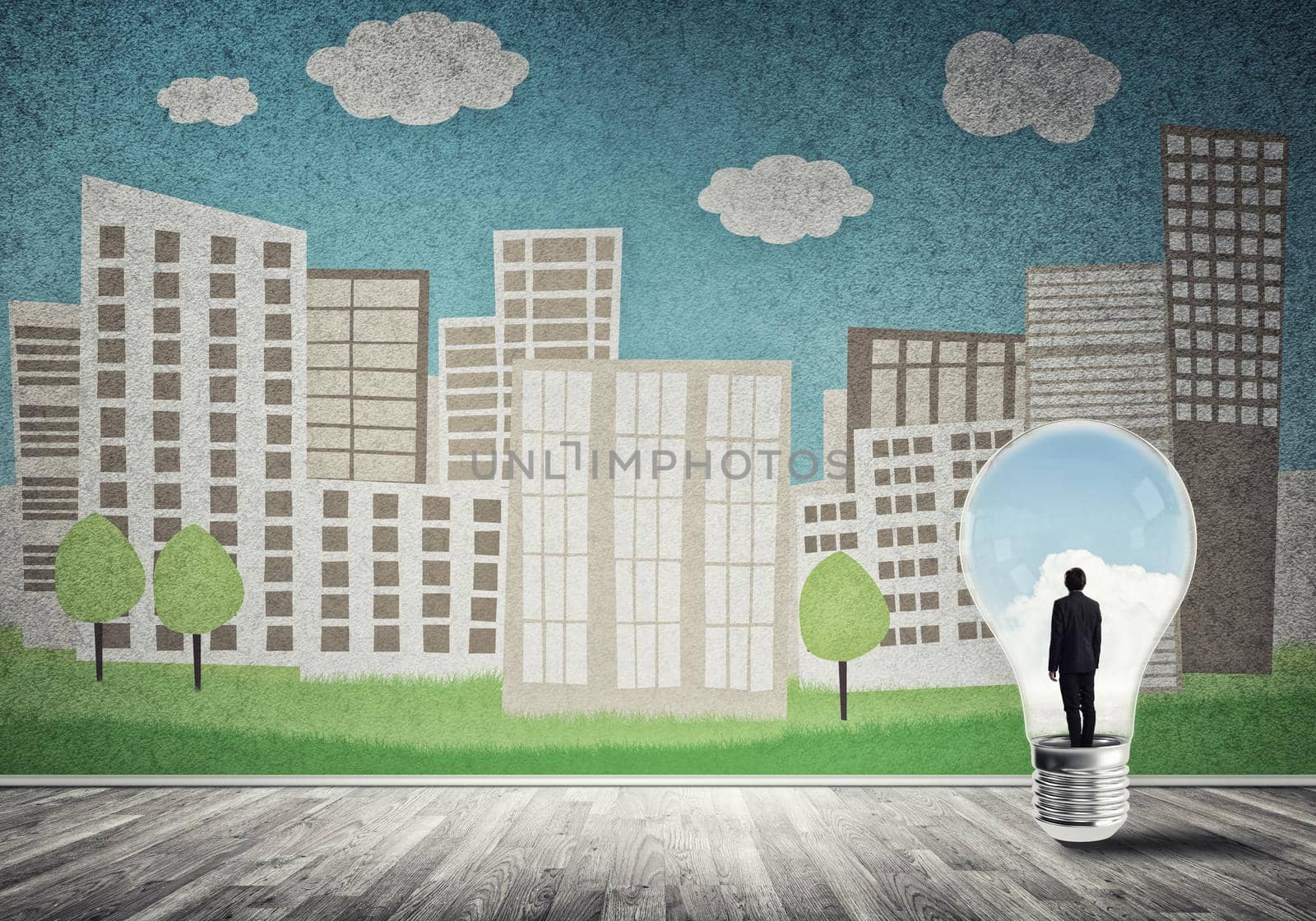 Businessman inside light bulb against city drawn concept