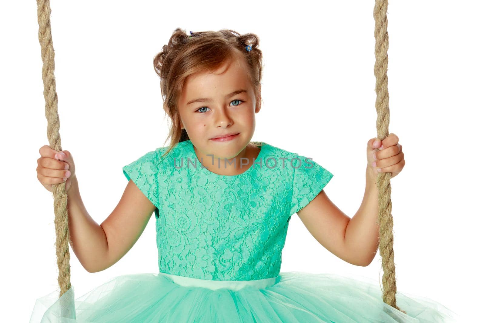 Beautiful little girl swinging on swing. The concept of family happiness, child development, sports education and summer recreation. Isolated on white background.