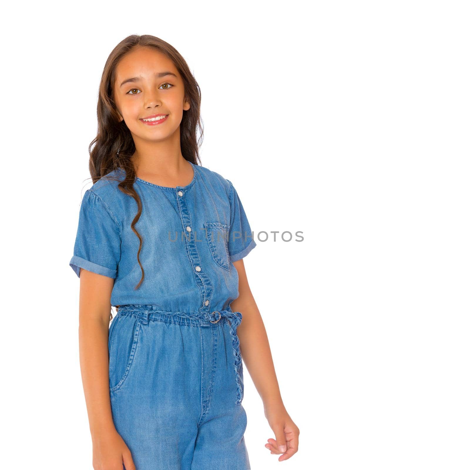 Portrait of a beautiful asian teenage girl with long black hair, in denim overalls. The concept of advertising a healthy lifestyle, beauty and fashion. Isolated on white background.
