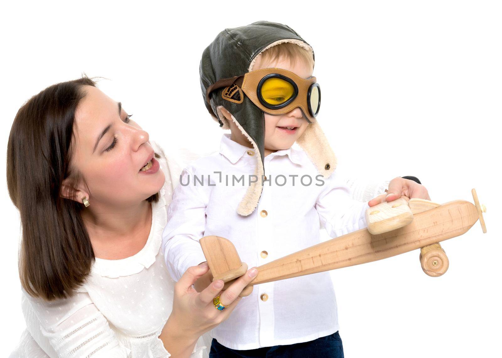 Mom and son are playing with a toy wooden plane. The concept of a happy childhood, raising a child in the family. Isolated on white background.
