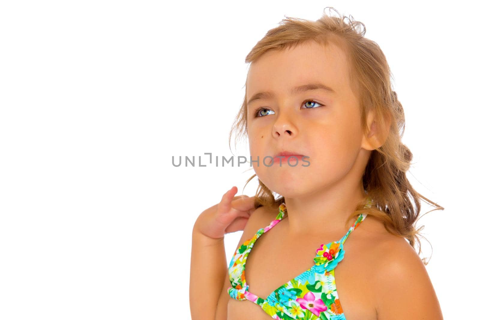 Tanned little girl in a swimsuit. The concept of summer family vacations in the sea. Happy childhood. Isolated on white background.