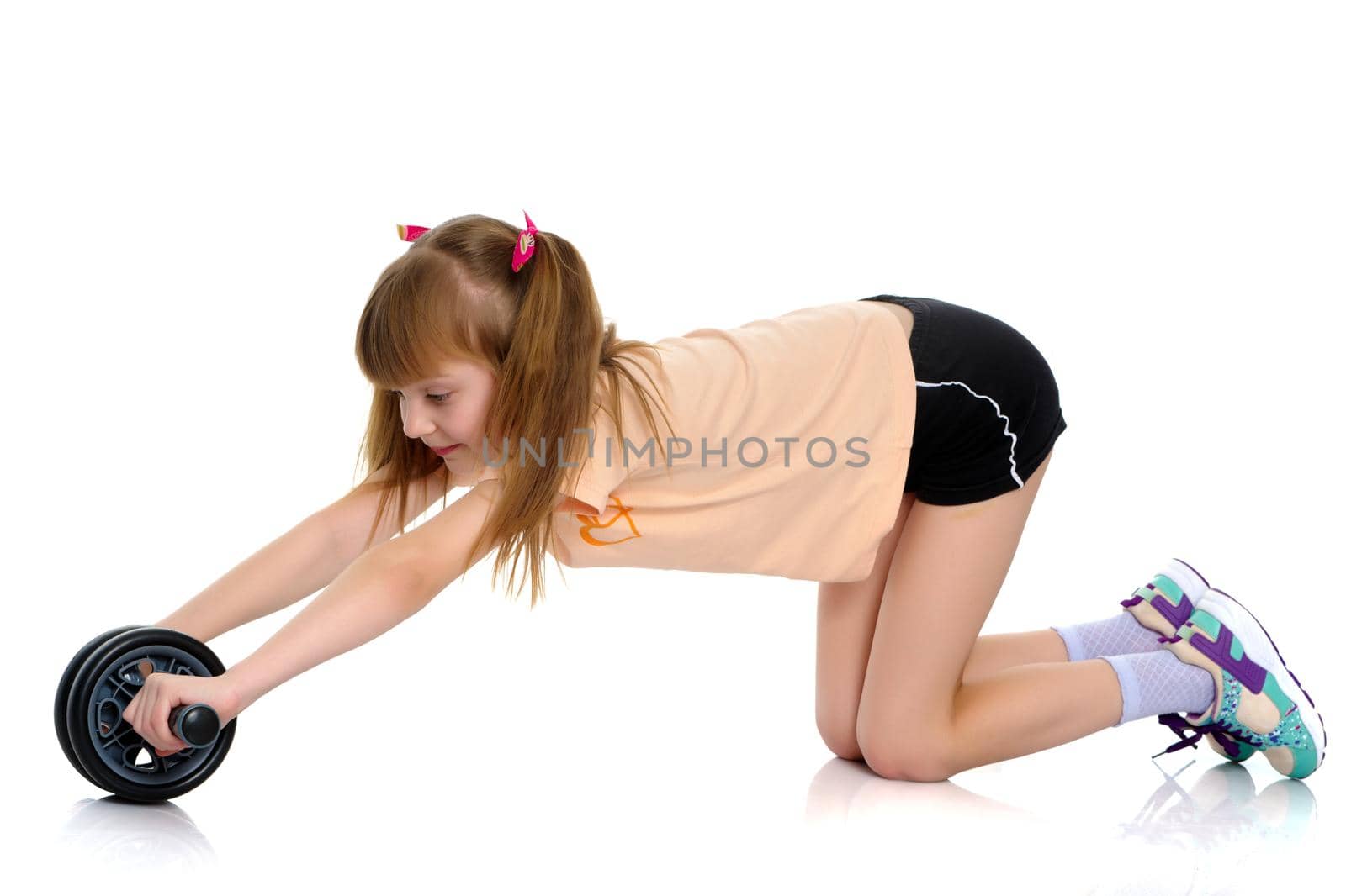 A nice little girl is performing gymnastic exercises. Concept of a healthy lifestyle, sport and fitness. Isolated on white background.