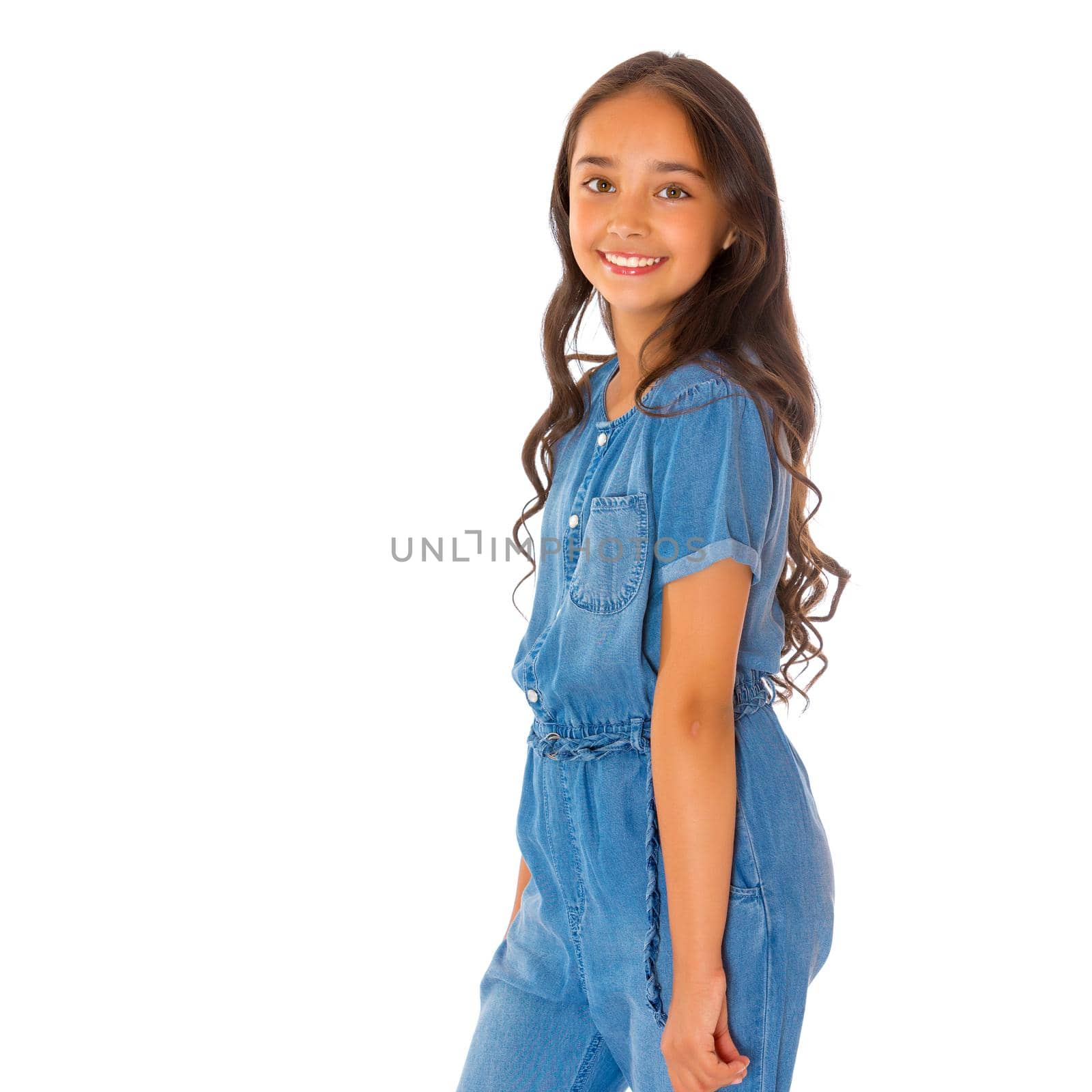 Portrait of a beautiful asian teenage girl with long black hair, in denim overalls. The concept of advertising a healthy lifestyle, beauty and fashion. Isolated on white background.