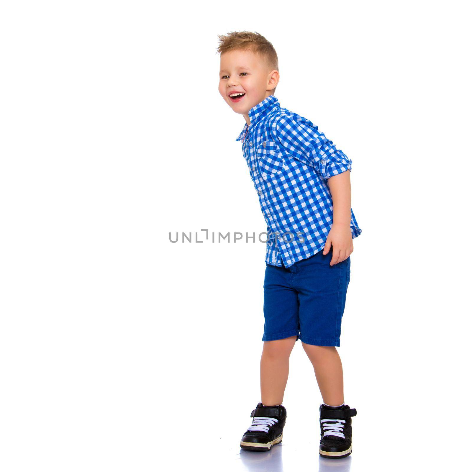 A cute little boy in a shirt and shorts. by kolesnikov_studio
