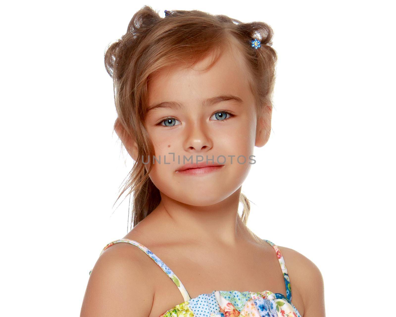 Tanned little girl in a swimsuit. The concept of summer family vacations in the sea. Happy childhood. Isolated on white background.