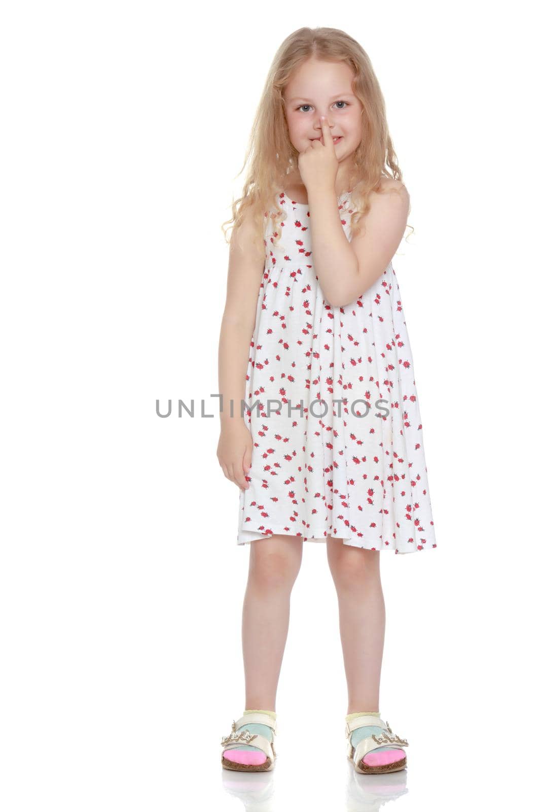 Little girl, the gesture is quiet. The concept of secrecy, games, observance of silence. Isolated over white background