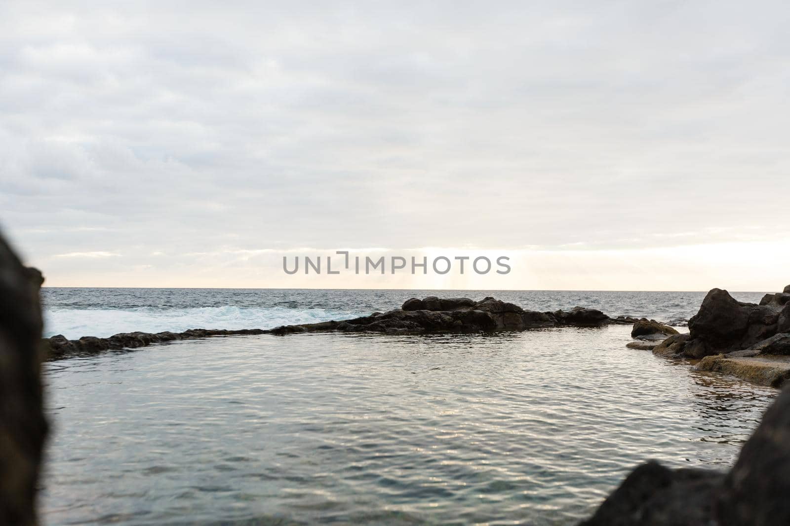 Old stone pier in sunset time at Tenerife, Canary Islands, Spain.