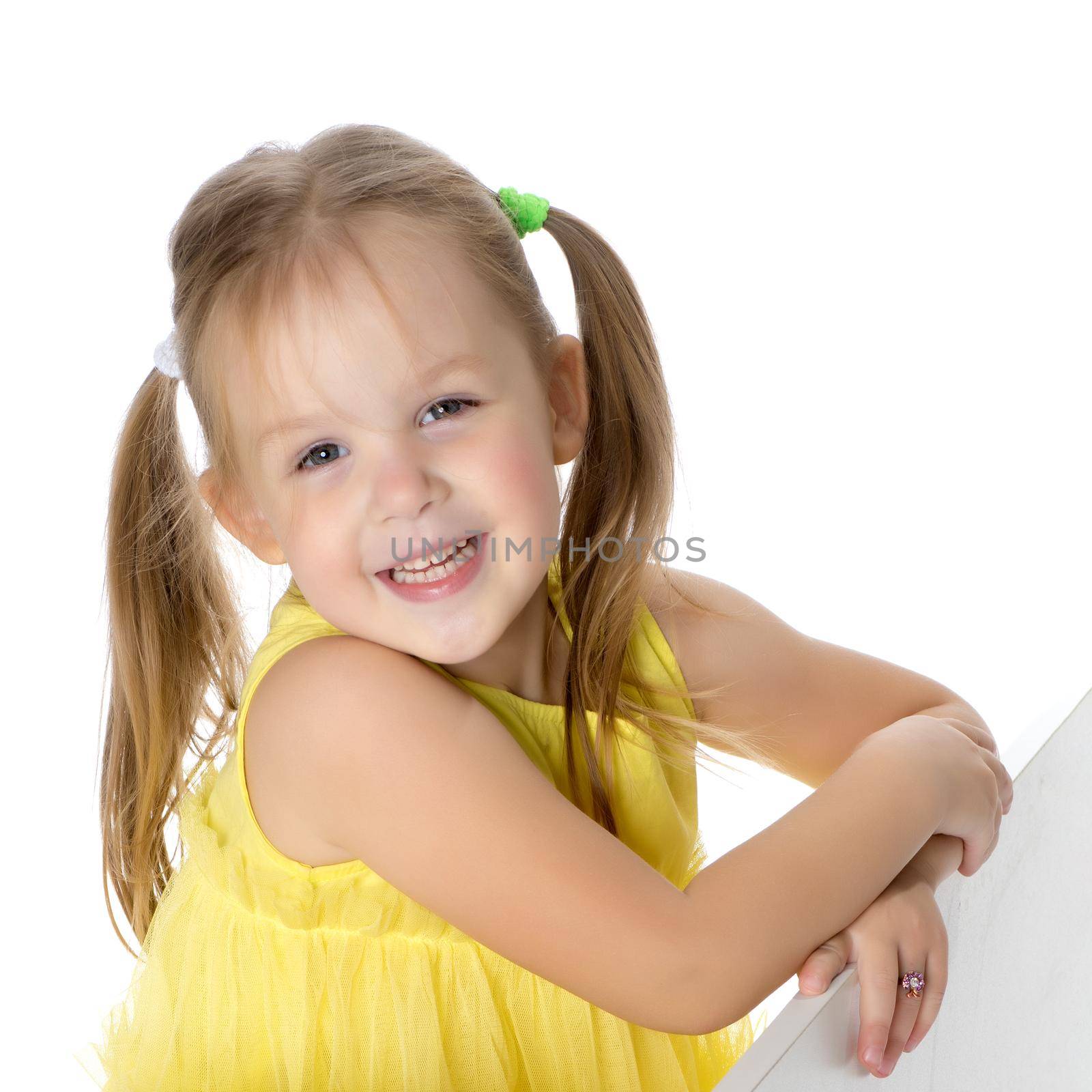 Fashionable little girl in a dress. Beauty and style in children's clothes. Isolated over white background