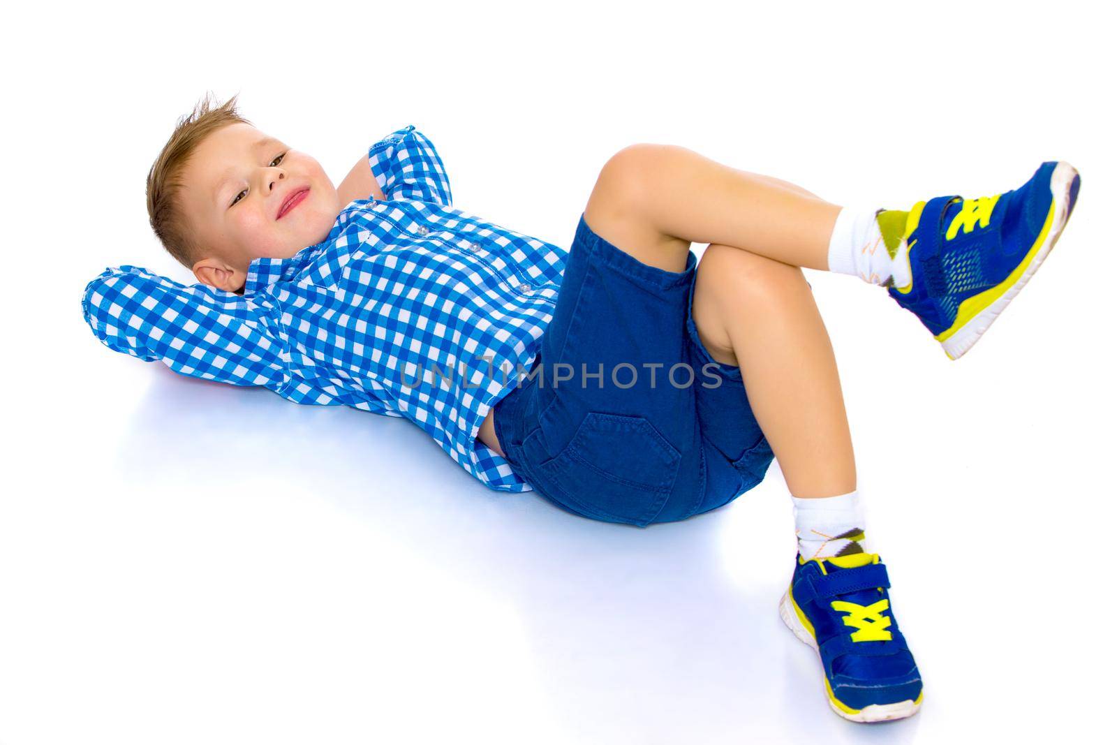 A cute little boy in a shirt and shorts. The concept of a summer family vacation, a happy childhood. Isolated on white background.