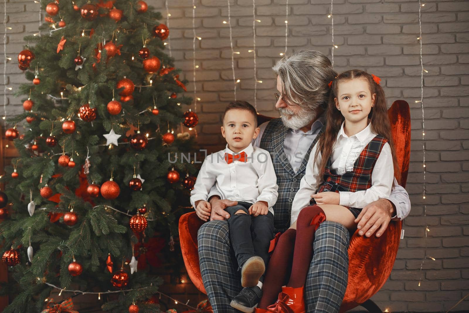 Smiling grandfather and grandchild sitting at home by prostooleh