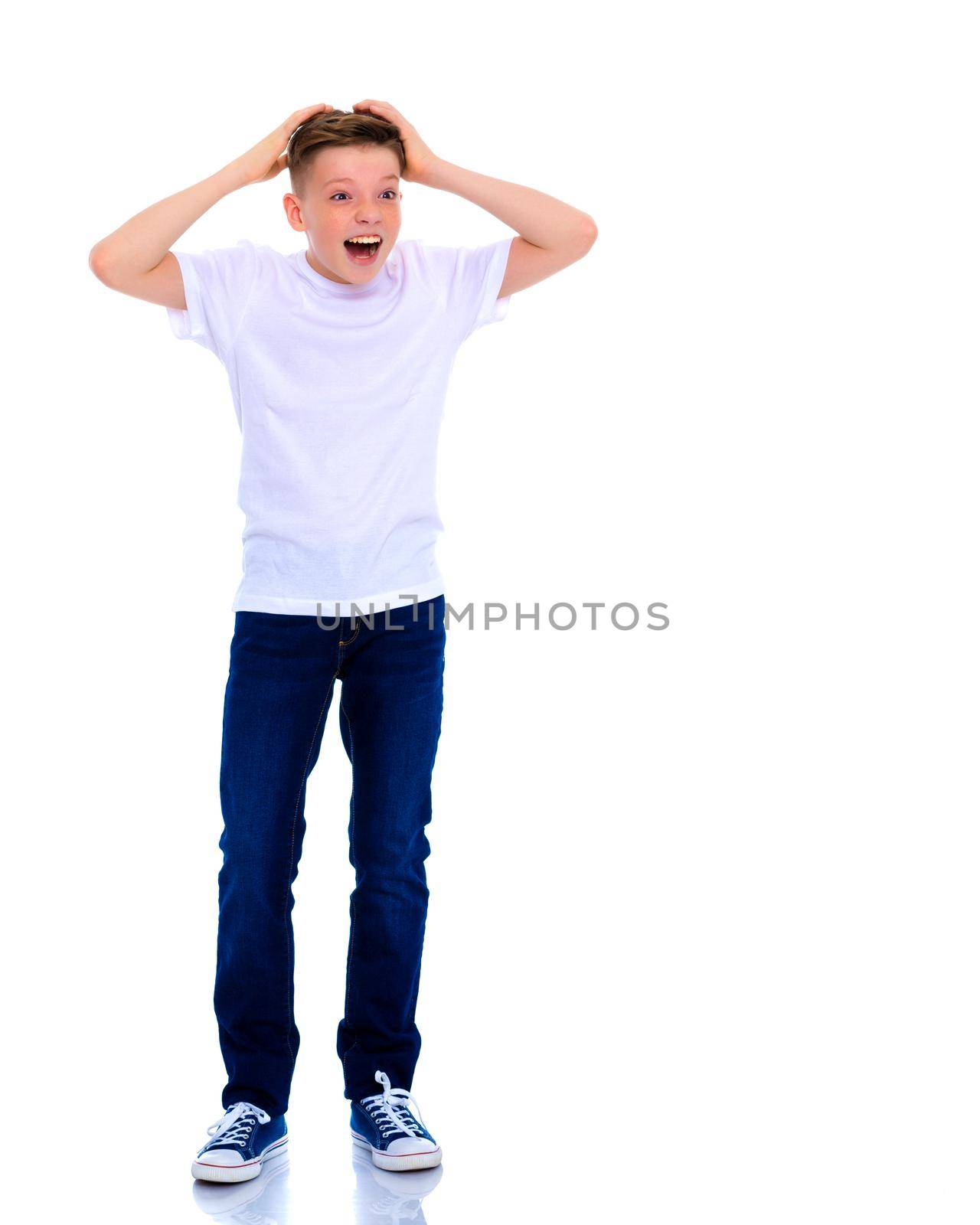 Emotional little boy of school age. The concept of reaction to various events. Isolated over white background