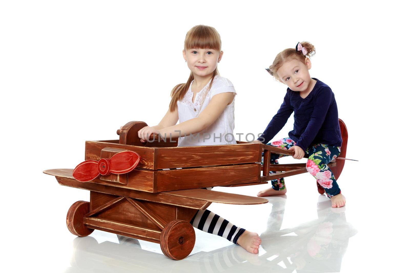 two sisters playing in a wooden plane by kolesnikov_studio