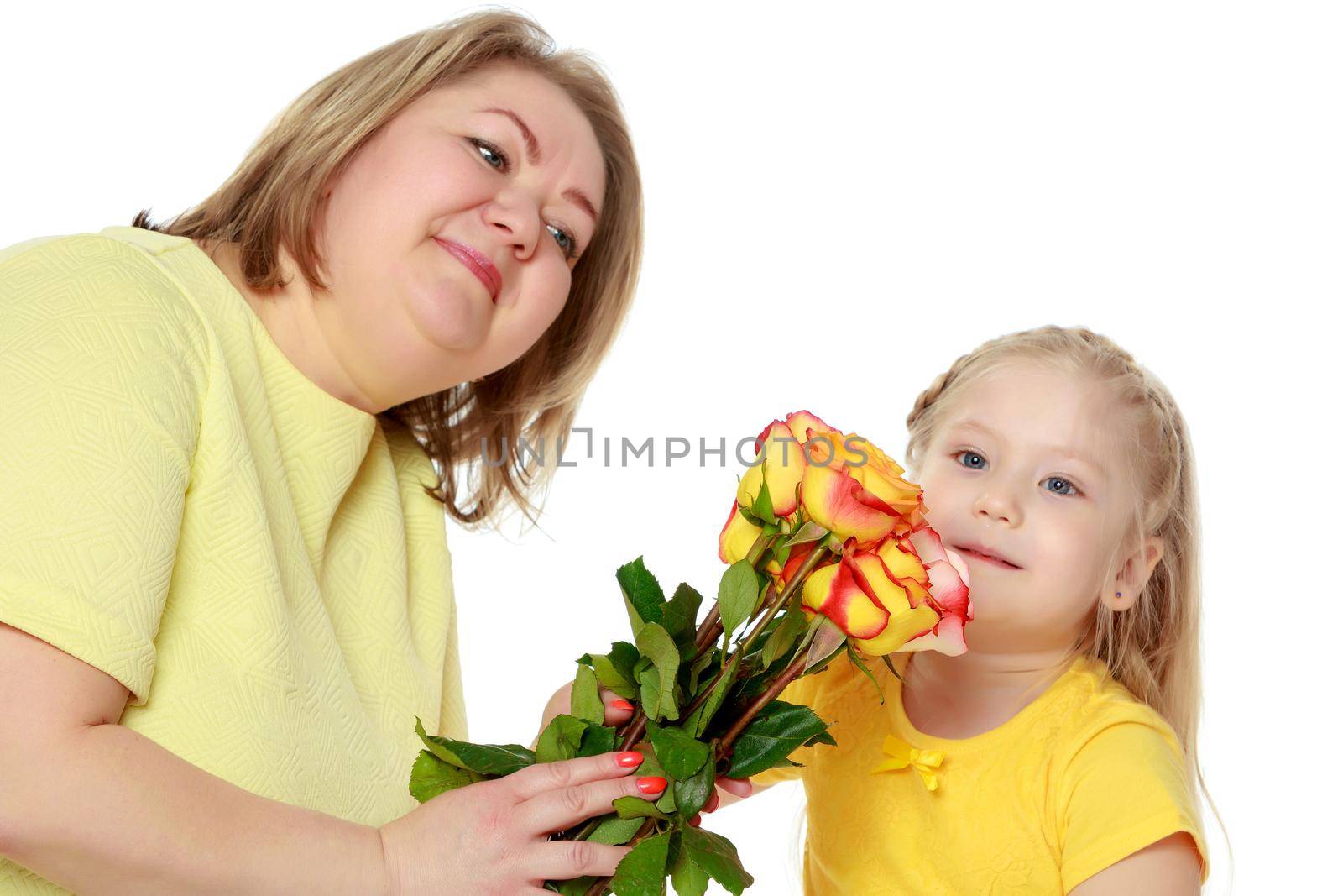 Mom and little daughter plus the size of the model, with a bouquet of flowers. A woman and a daughter smile in a happy manner. Good for the concept of health, happiness, diet, obesity, weight loss.