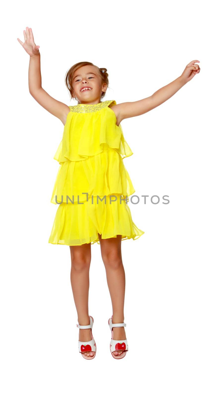 A little girl is jumping and waving her hands. The concept of a happy childhood, outdoor recreation. Isolated on white background.