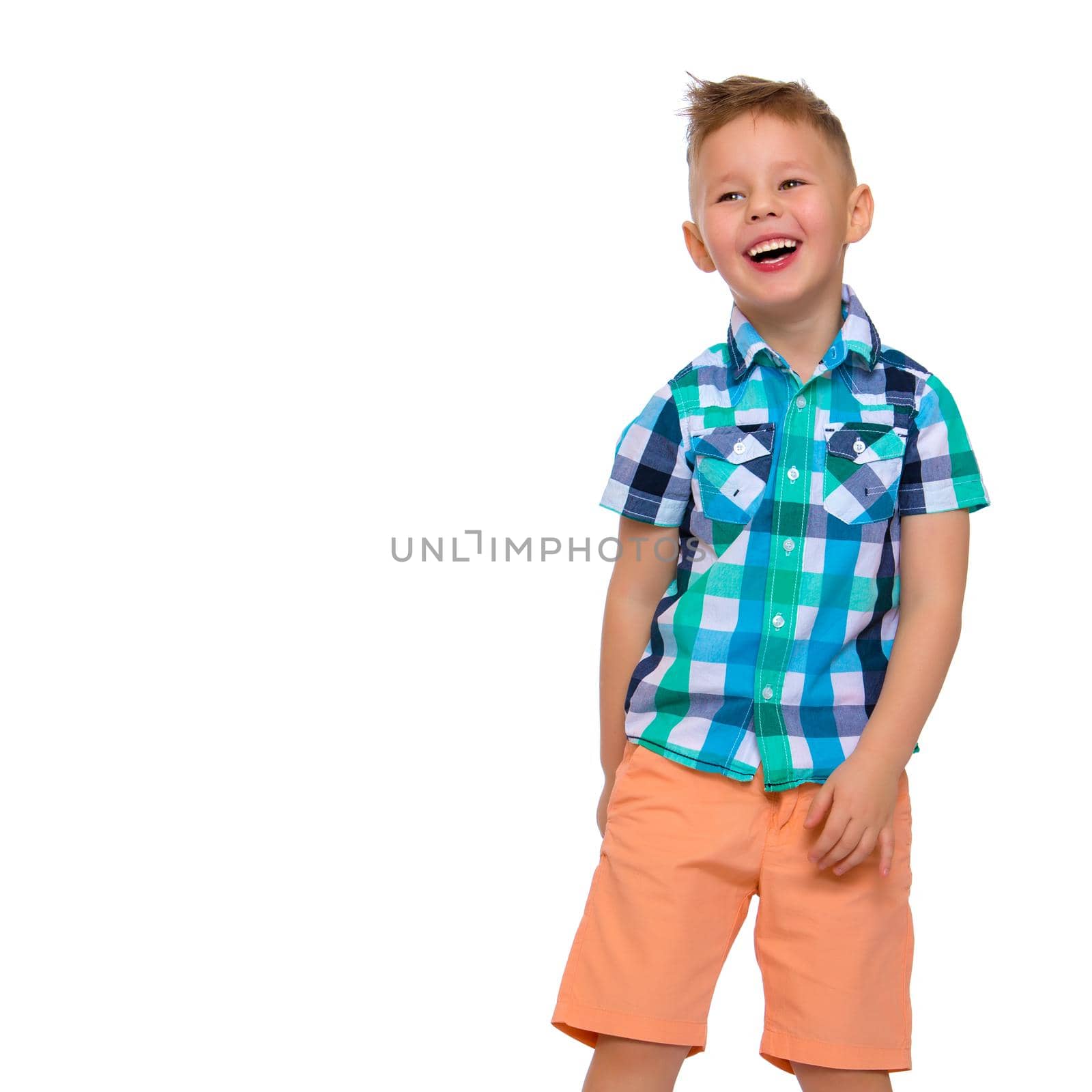 A cute little boy in a shirt and shorts. The concept of a summer family vacation, a happy childhood. Isolated on white background.